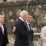 French President Emmanuel Macron slaps his face while visiting the city