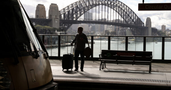 A man waits at a train platform as an outbreak of COVID-19 affects Sydney